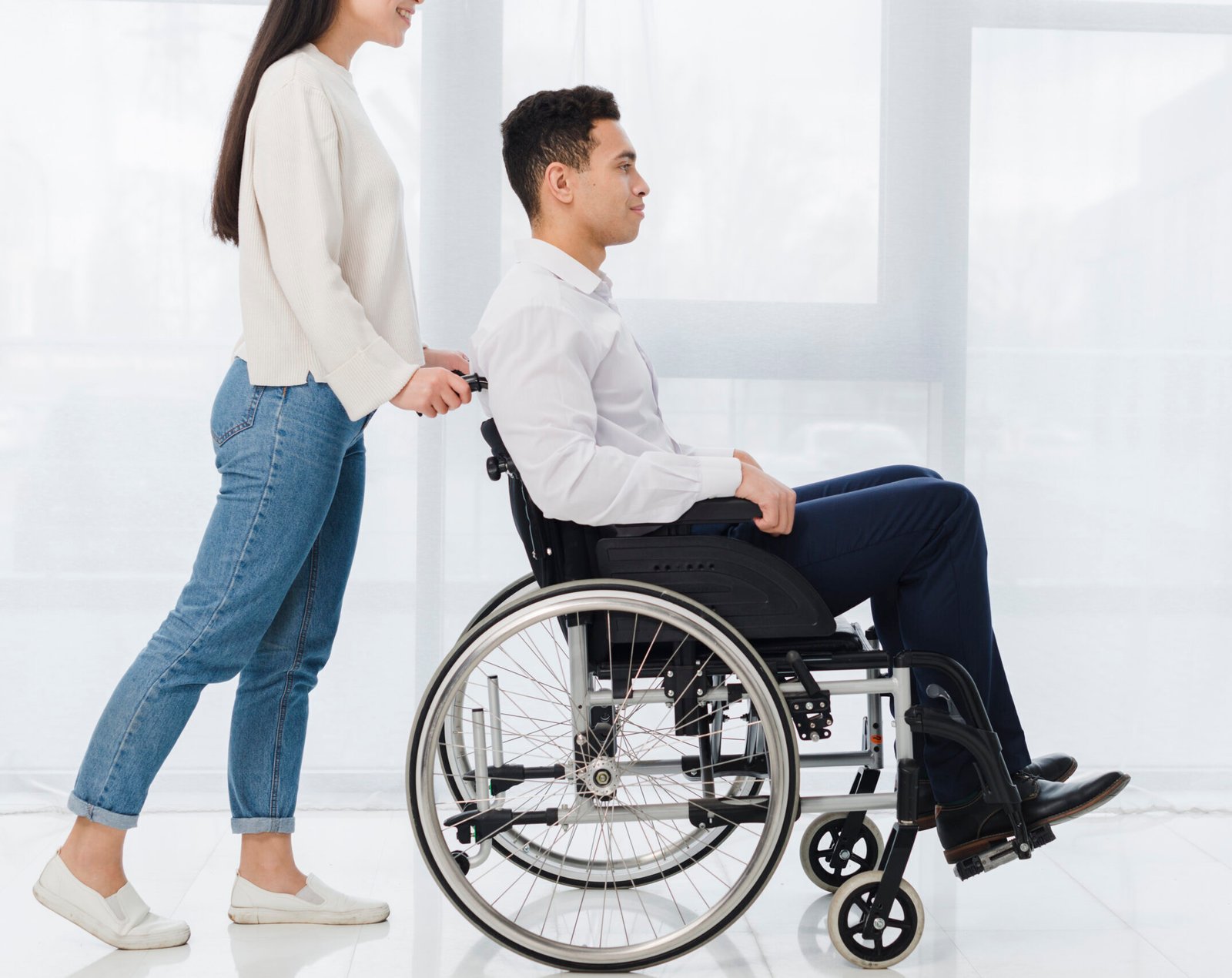Young man in wheelchair receiving support during paralysis recovery